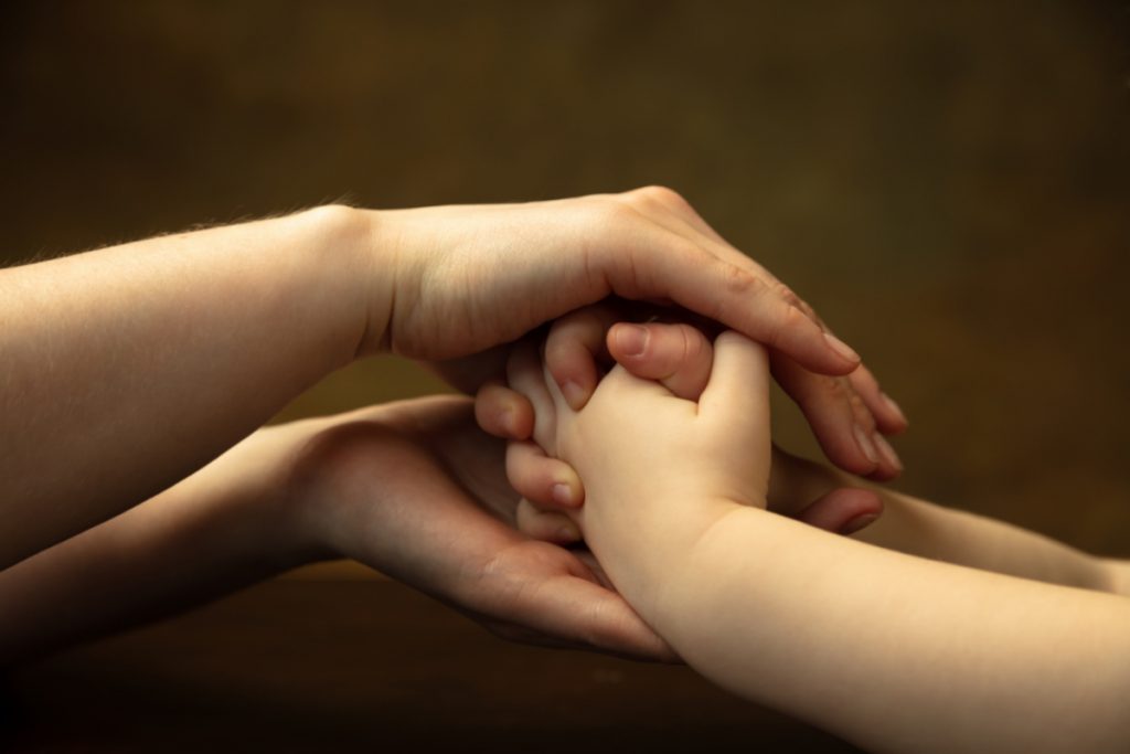 parent holding child hands (1)
